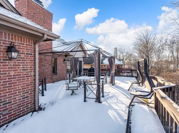 snow covered patio featuring a gazebo