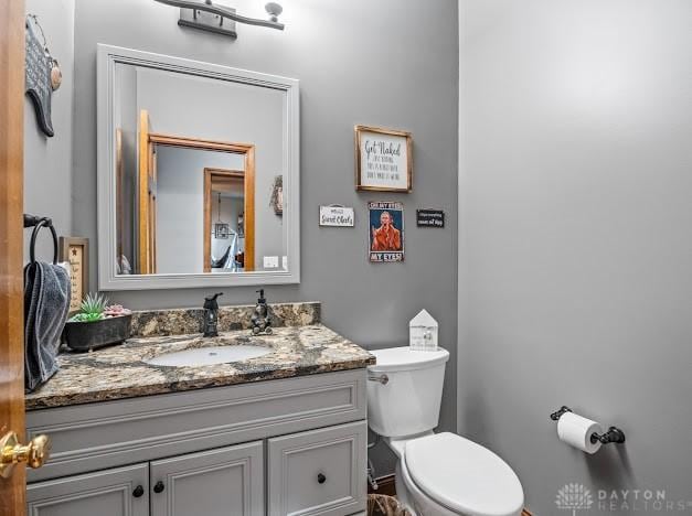 bathroom with toilet and vanity