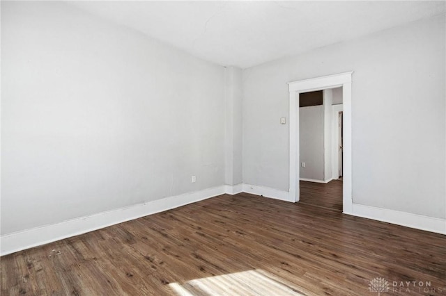 empty room with dark hardwood / wood-style floors