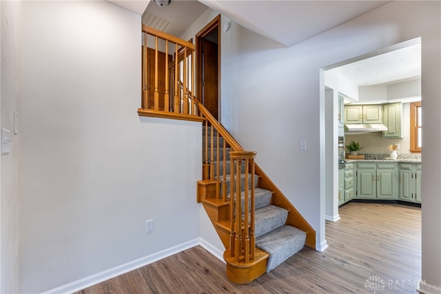 stairway featuring hardwood / wood-style flooring