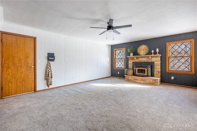 unfurnished living room featuring ceiling fan and carpet