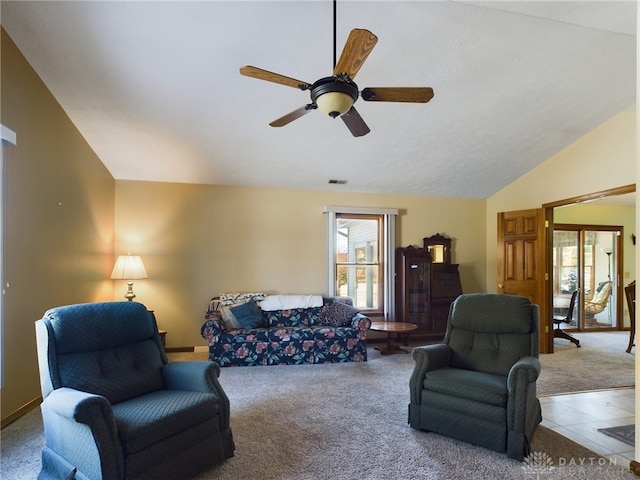 living room with lofted ceiling, ceiling fan, carpet, and a healthy amount of sunlight