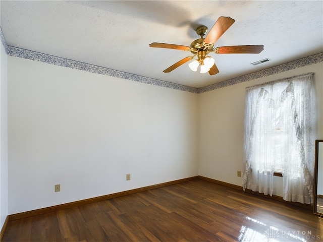 unfurnished room with ceiling fan and dark hardwood / wood-style floors