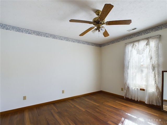 unfurnished room featuring ceiling fan and dark wood-type flooring