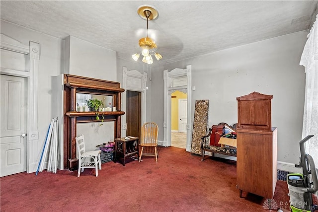 misc room featuring a textured ceiling, ceiling fan, and carpet