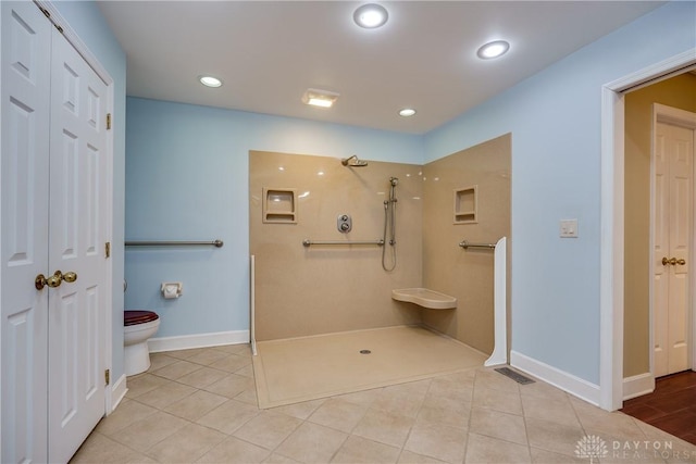 bathroom with toilet, tile patterned flooring, and walk in shower