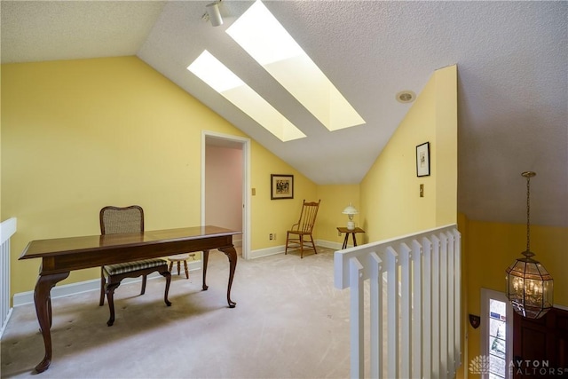 office space featuring carpet and lofted ceiling with skylight