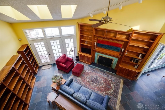 living room featuring ceiling fan and track lighting