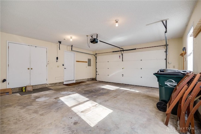 garage featuring a garage door opener and electric panel