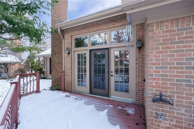 view of snow covered property entrance