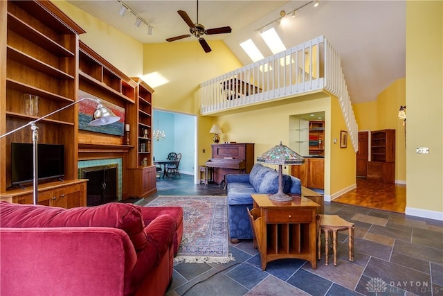 living room with ceiling fan and high vaulted ceiling