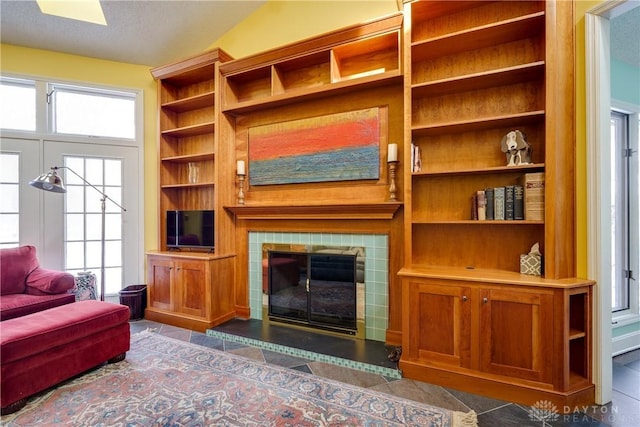 living room featuring lofted ceiling and a fireplace