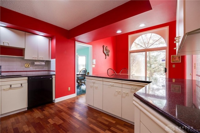 kitchen featuring decorative backsplash, dishwasher, white cabinetry, and dark hardwood / wood-style floors