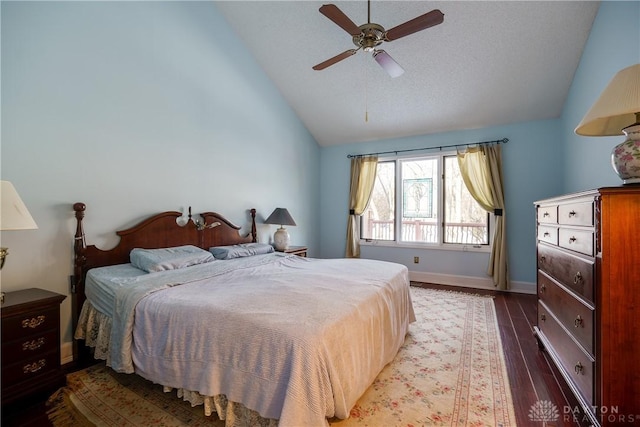 bedroom with vaulted ceiling, ceiling fan, and dark hardwood / wood-style flooring