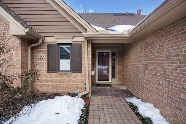 view of snow covered property entrance