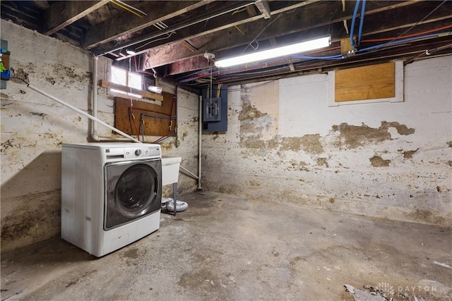 basement featuring electric panel and washer / clothes dryer