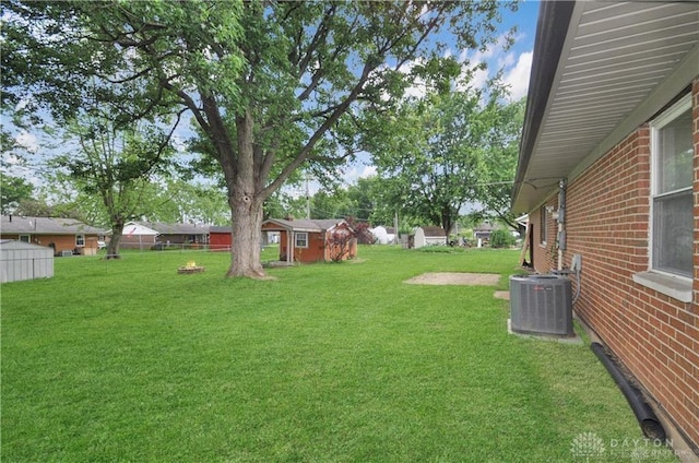 view of yard with an outdoor structure and central air condition unit