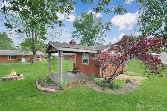 view of yard featuring a fire pit and a deck