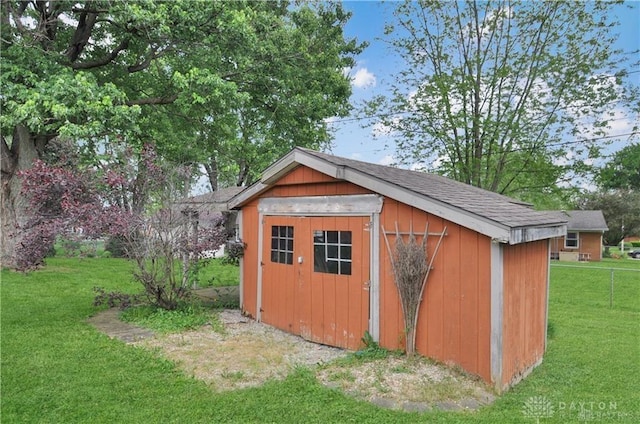 view of outbuilding featuring a lawn