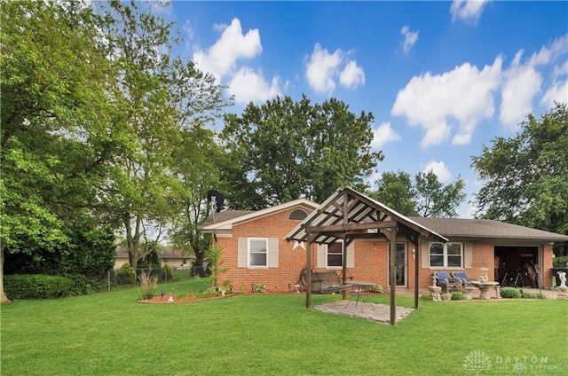 view of front of house with a patio area and a front yard