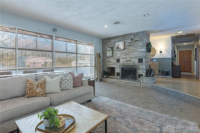 carpeted living room featuring a fireplace