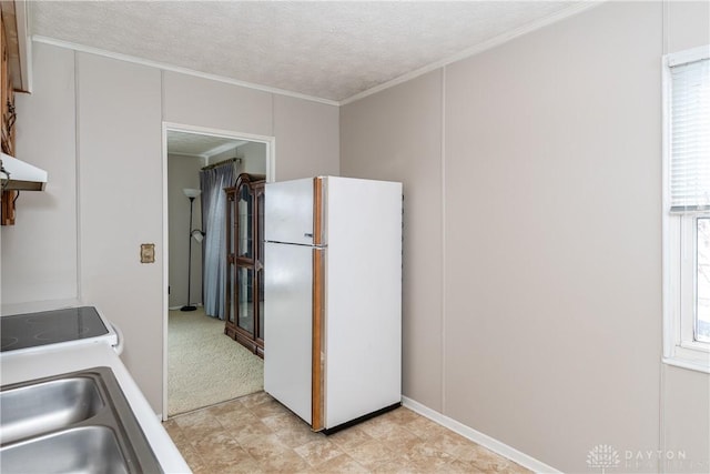 kitchen with ornamental molding, a textured ceiling, white refrigerator, range, and sink