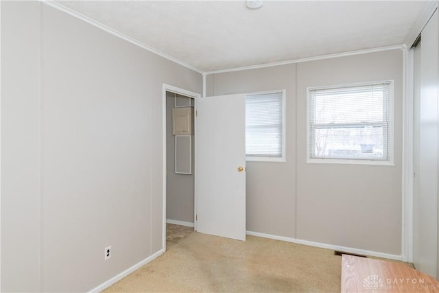 unfurnished bedroom with light colored carpet, a closet, and ornamental molding