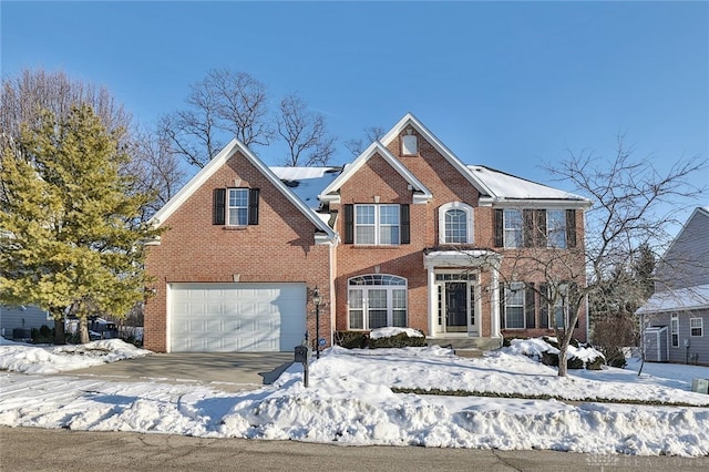 colonial inspired home featuring a garage and brick siding