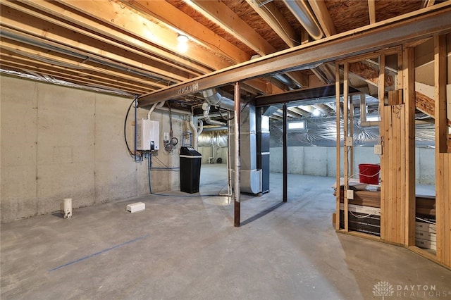 unfinished basement featuring tankless water heater and heating unit