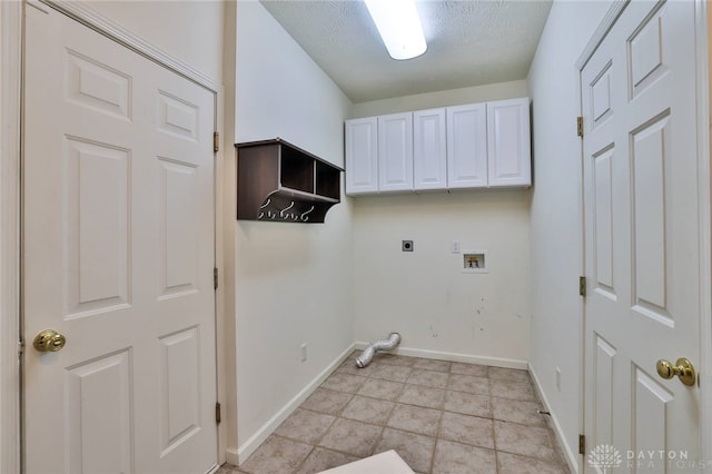 washroom with a textured ceiling, hookup for a washing machine, baseboards, cabinet space, and electric dryer hookup