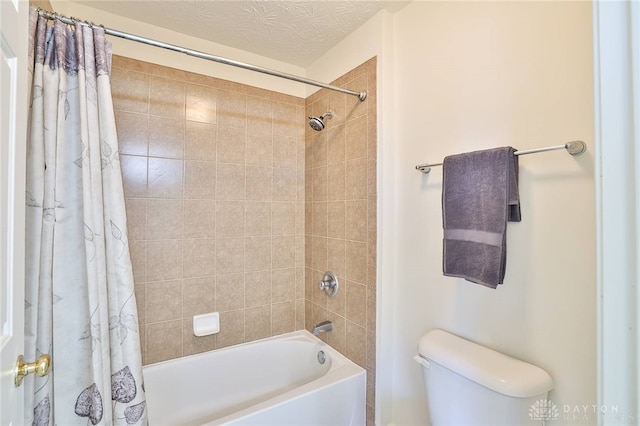 full bathroom with shower / bathtub combination with curtain, a textured ceiling, and toilet