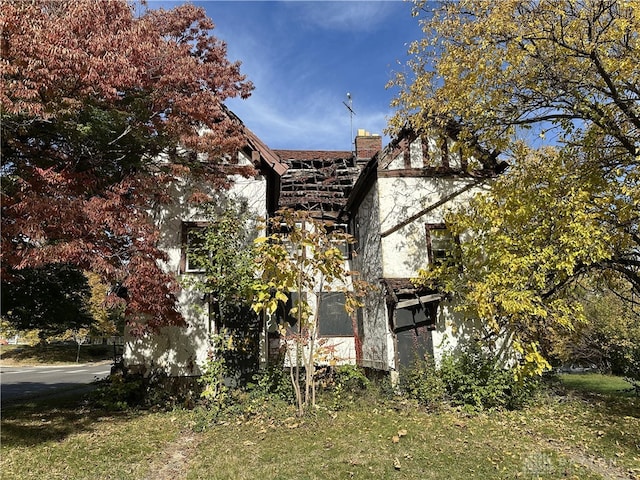 view of property exterior with a lawn