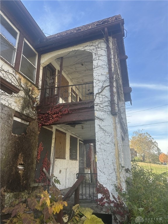 view of side of home featuring a balcony