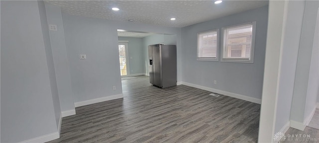 spare room featuring dark wood-type flooring