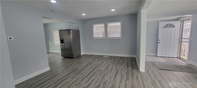 foyer entrance featuring dark wood-type flooring and a textured ceiling