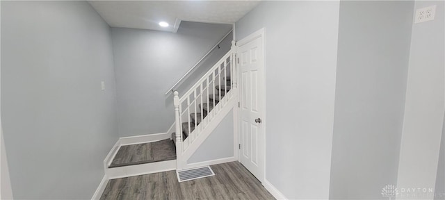 stairway featuring hardwood / wood-style floors