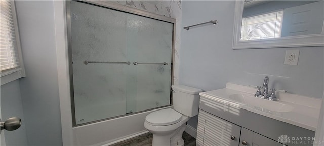 full bathroom with toilet, enclosed tub / shower combo, wood-type flooring, and vanity