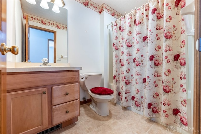 bathroom featuring vanity, toilet, and tile patterned floors