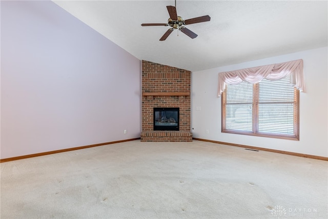 unfurnished living room featuring vaulted ceiling, light colored carpet, and a fireplace