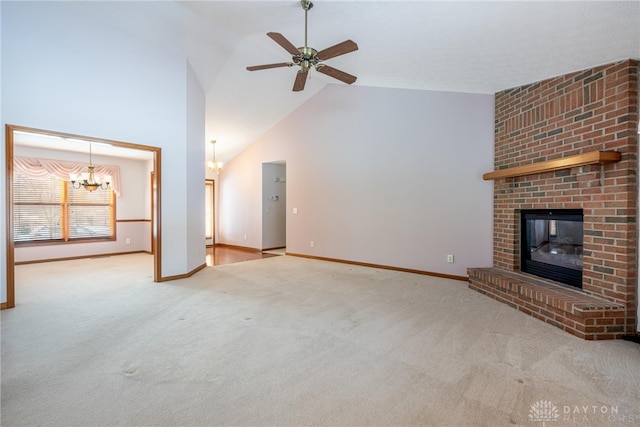 unfurnished living room featuring carpet floors, ceiling fan with notable chandelier, a fireplace, and lofted ceiling