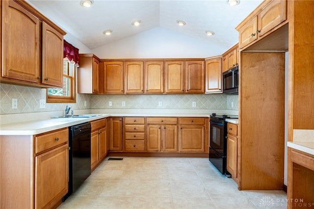 kitchen featuring black appliances, decorative backsplash, sink, vaulted ceiling, and light tile patterned flooring