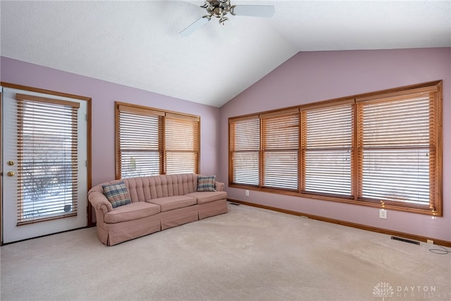 living room with ceiling fan, light carpet, and lofted ceiling