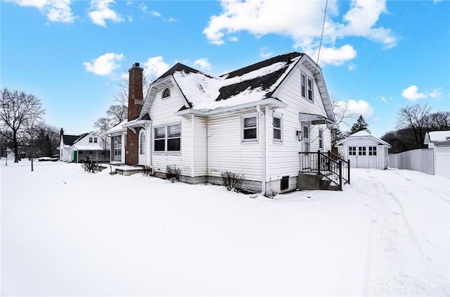 view of snow covered exterior featuring an outdoor structure