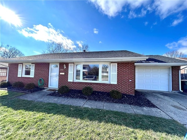 single story home with a garage and a front lawn