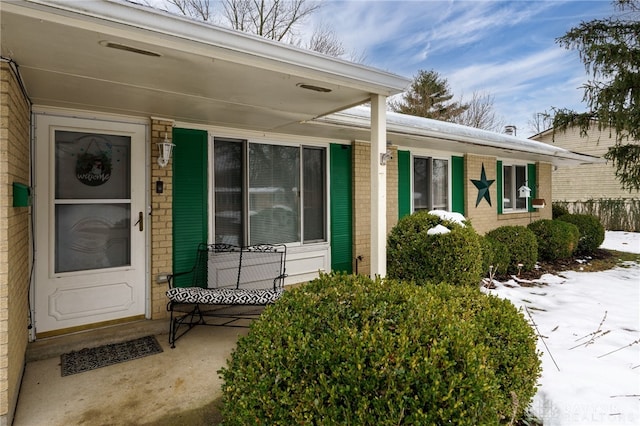 view of snow covered property entrance