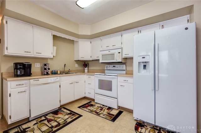 kitchen with sink, white cabinetry, and white appliances