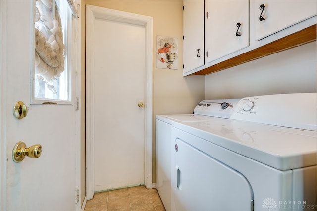 laundry room with light tile patterned floors, cabinets, and independent washer and dryer