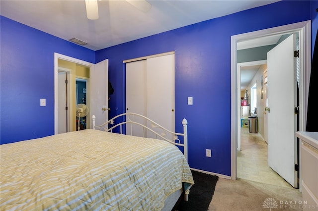 bedroom with light carpet, a closet, and ceiling fan