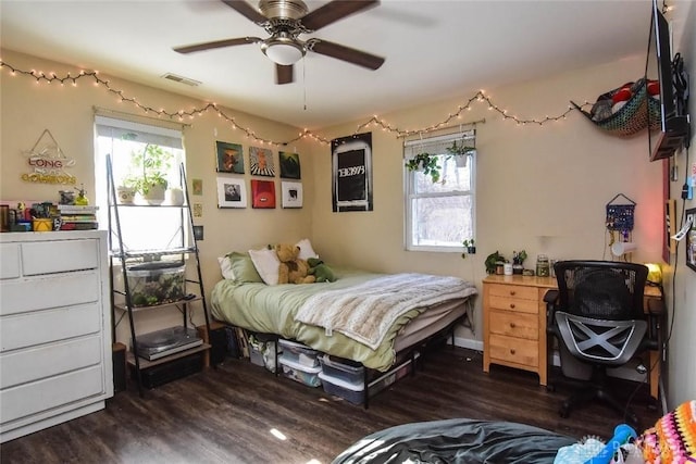 bedroom with ceiling fan and dark hardwood / wood-style flooring