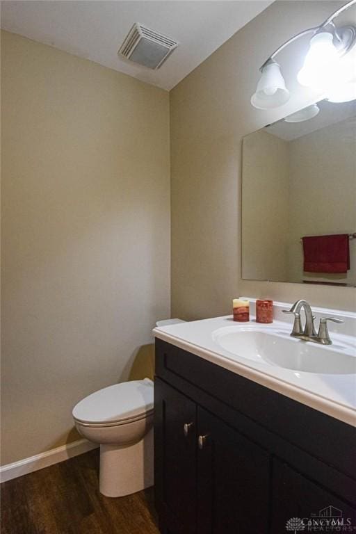 bathroom featuring hardwood / wood-style floors, toilet, and vanity